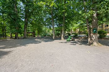 a park with trees and a green bench at Stuart Woods* Apartments, Herndon, VA, 20170